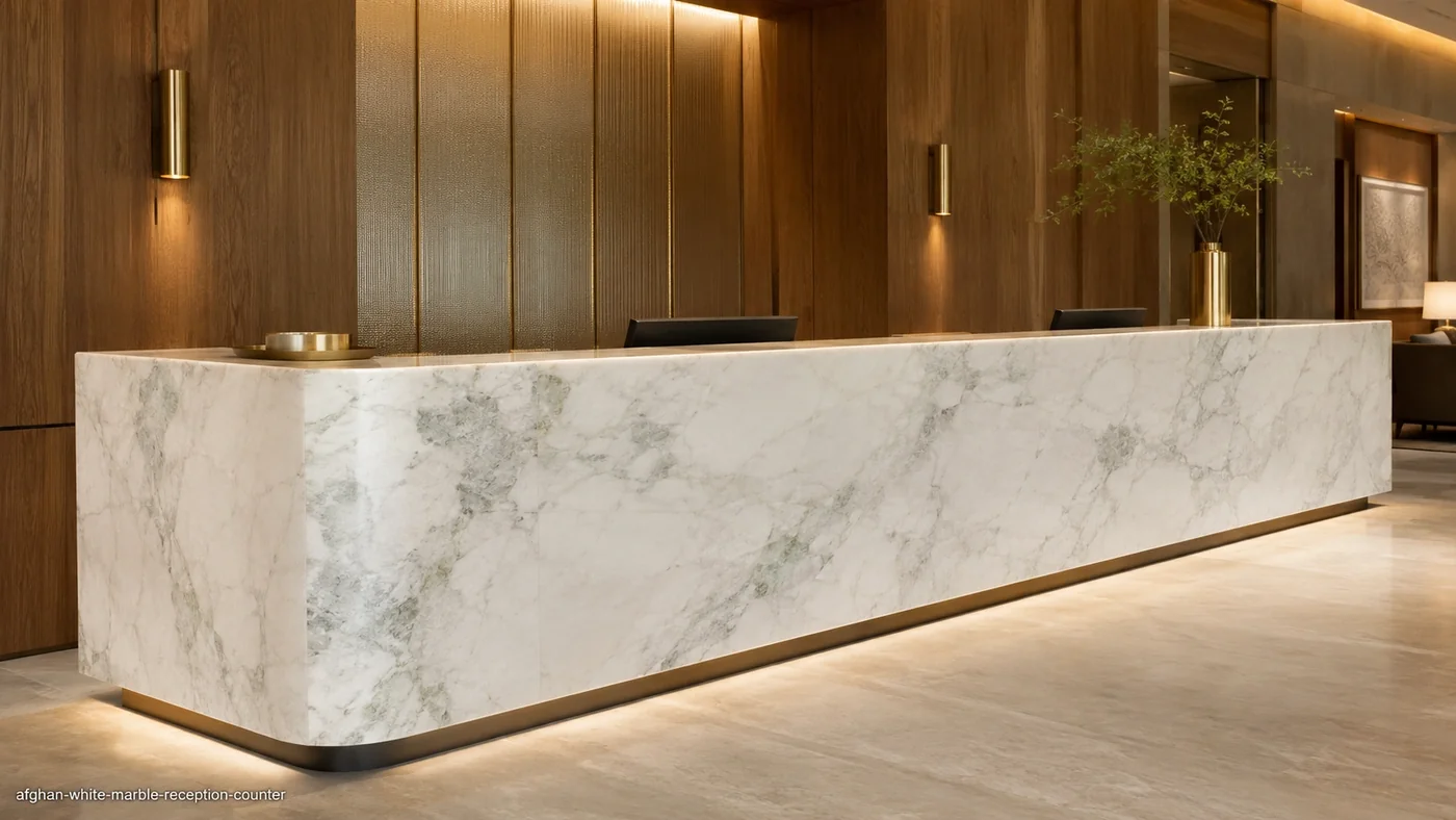 Afghan White Marble reception counter with a crystalline white finish and subtle grey veining in a luxury hotel lobby.