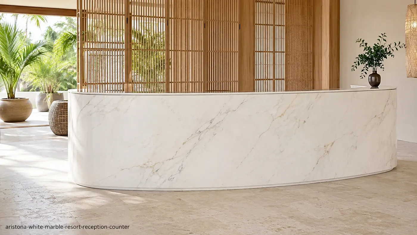 Aristona White Marble resort reception counter with clean white stone, fine grey veins and pale-gold traces.