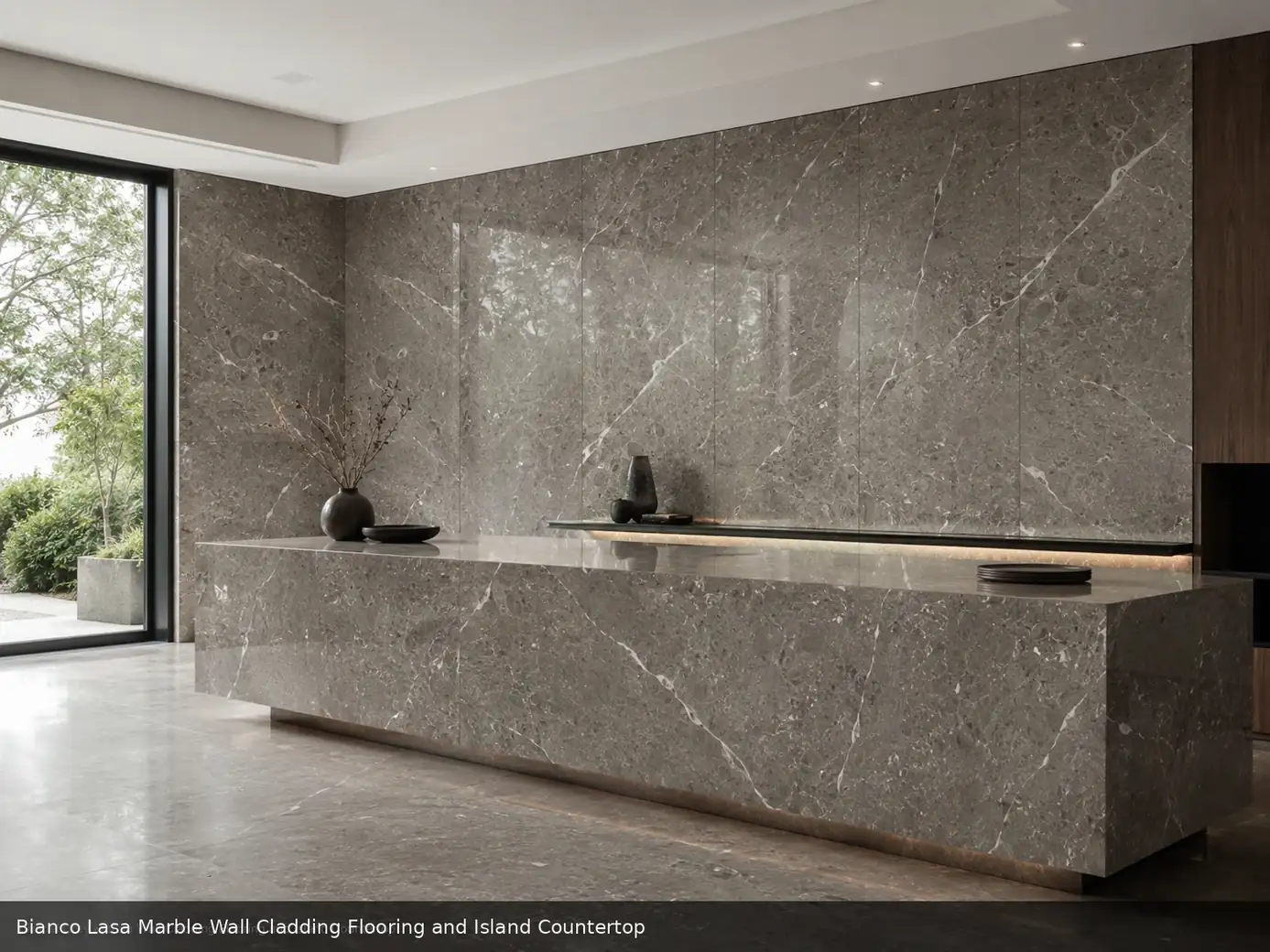 bright luxury interior stone across wall cladding, floor and island countertop, with natural veining in a refined interior.