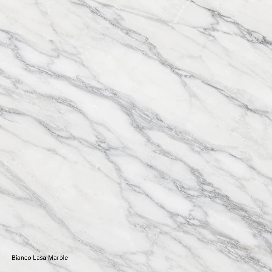 Bianco Lasa Marble featuring ultra pure crystalline stone, snow-white fields, blue-grey veins and a luminous polished finish.