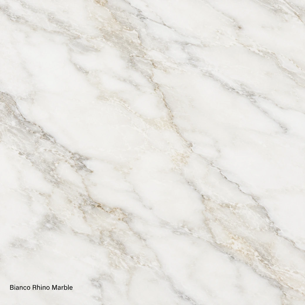 Bianco Rhino Marble with luminous crystalline white stone, creamy clouds, beige-gold wisps and a polished luminous finish.