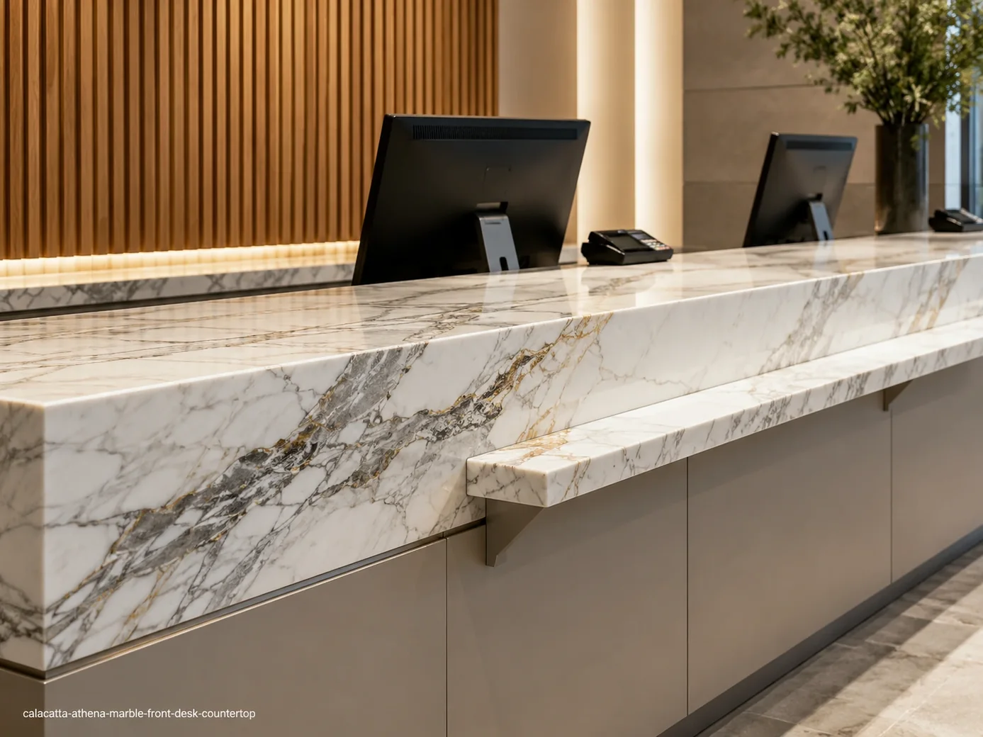 Calacatta Athena Marble front desk countertop with crisp white stone, grey ribbons and subtle honey-gold accents.