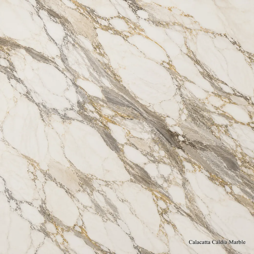 Calacatta Caldia Marble with warm white softly veined stone, feathered grey lines, green-grey movement and honey accents.