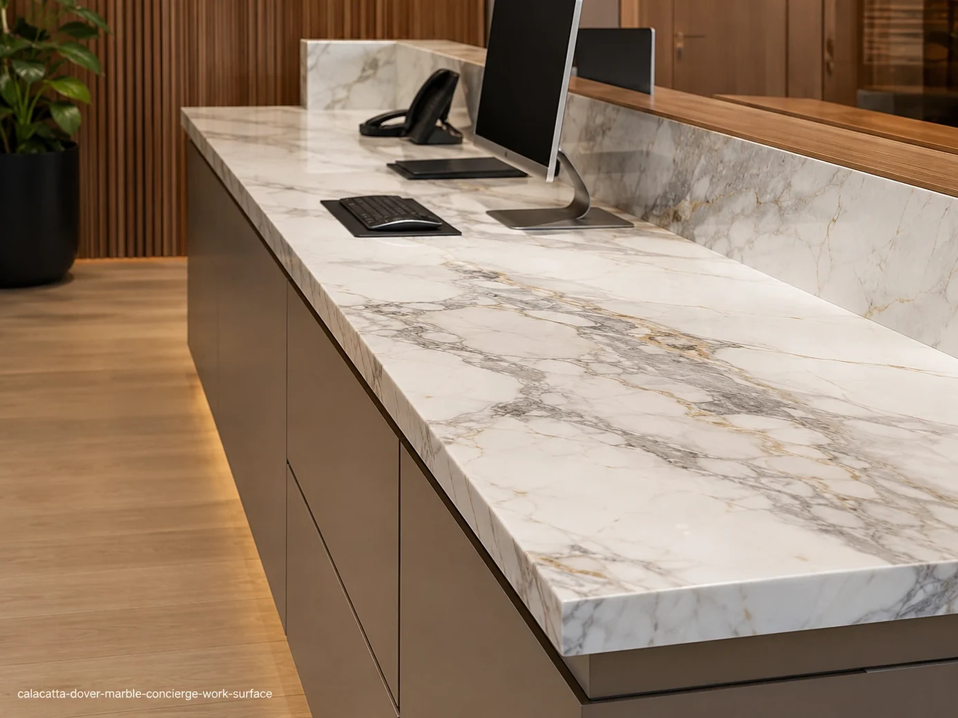 Calacatta Dover Marble concierge work surface with bright white stone, flowing grey veins and sparse gold accents.