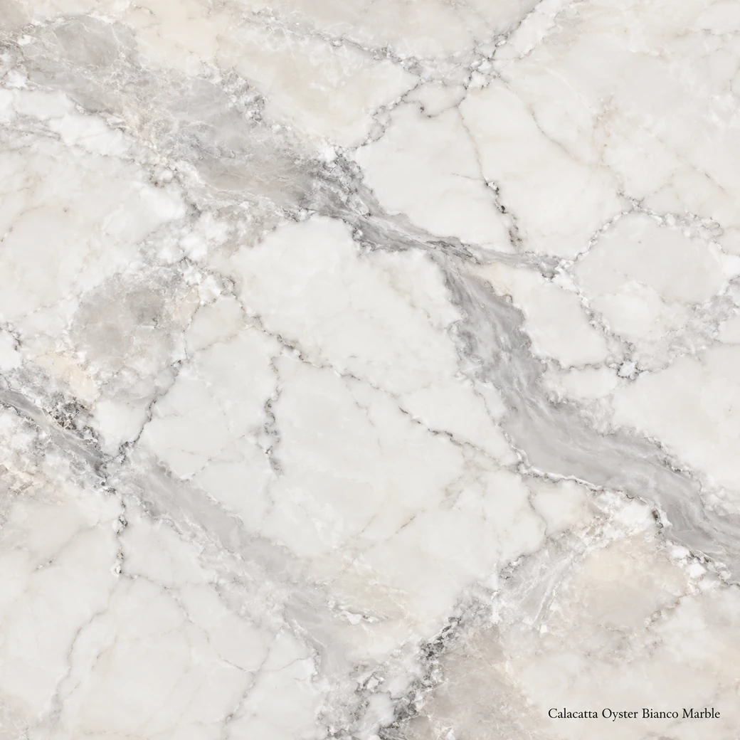 Calacatta Oyster Bianco Marble with pearly white mineral surface, oyster-grey clouds, soft veins and polished shell sheen.