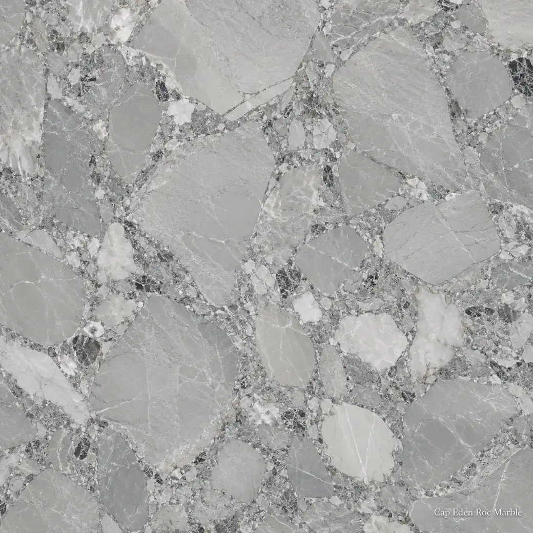 Cap Eden Roc Marble with coastal luxury feature stone, silver-grey clasts, white fragments and polished architectural depth.
