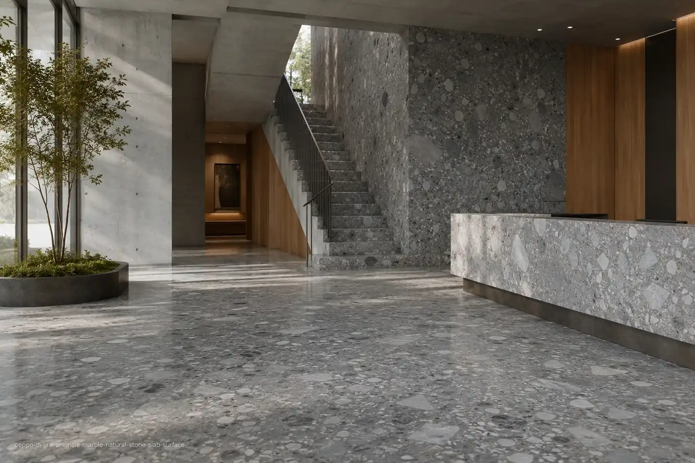 Bold conglomerate slab across a lobby floor, staircase, wall cladding and reception counter with blue-grey mineral pebbles.