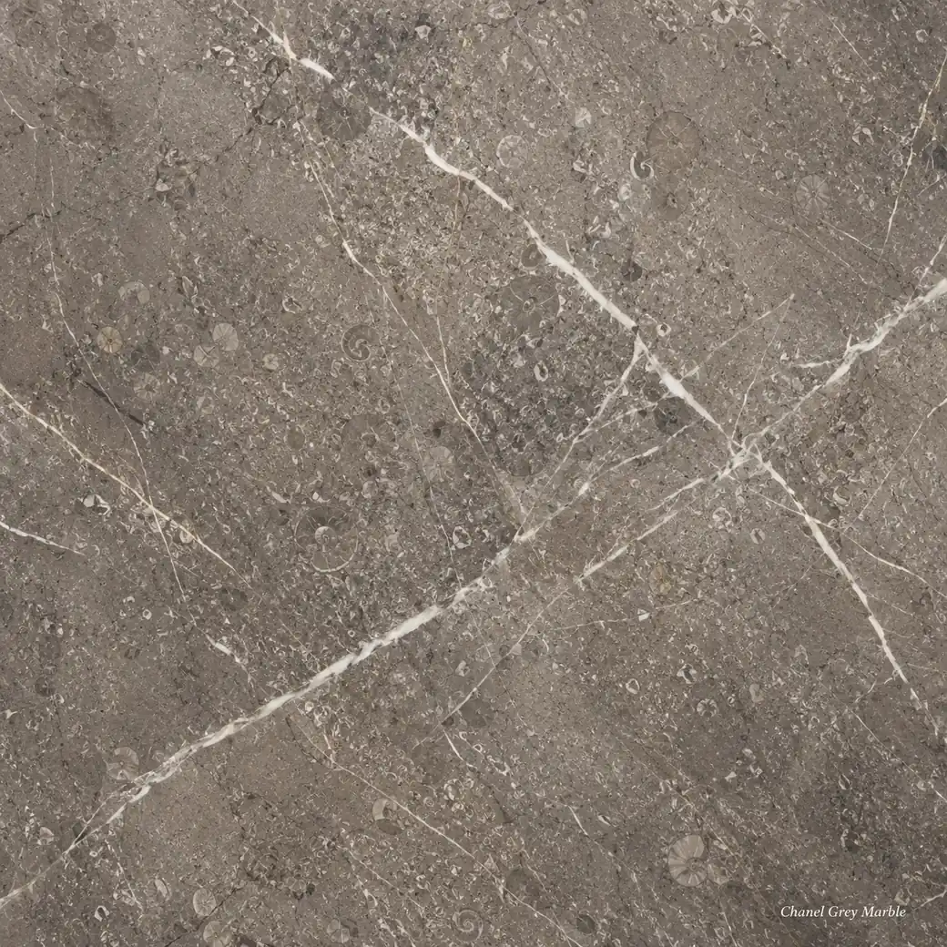 Chanel Grey Marble with fashion inspired grey stone, ivory calcite veins, fossil details and a rich polished taupe finish.