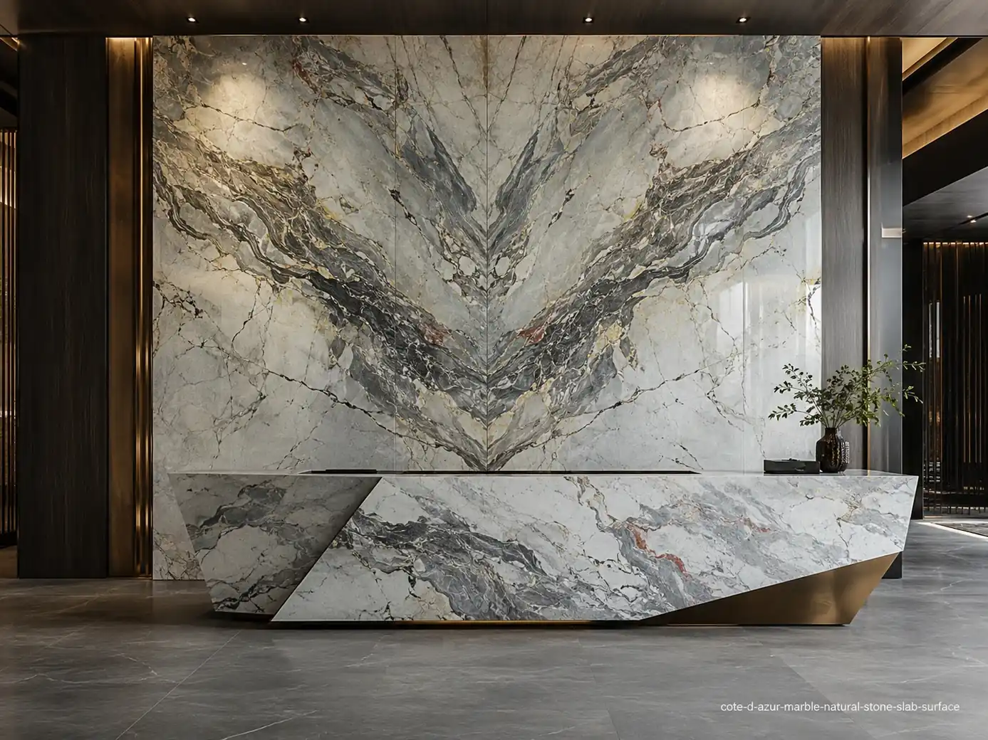 Elegant coastal architectural slab on a lobby wall and reception counter with grey, charcoal, blue and rust mineral veins.