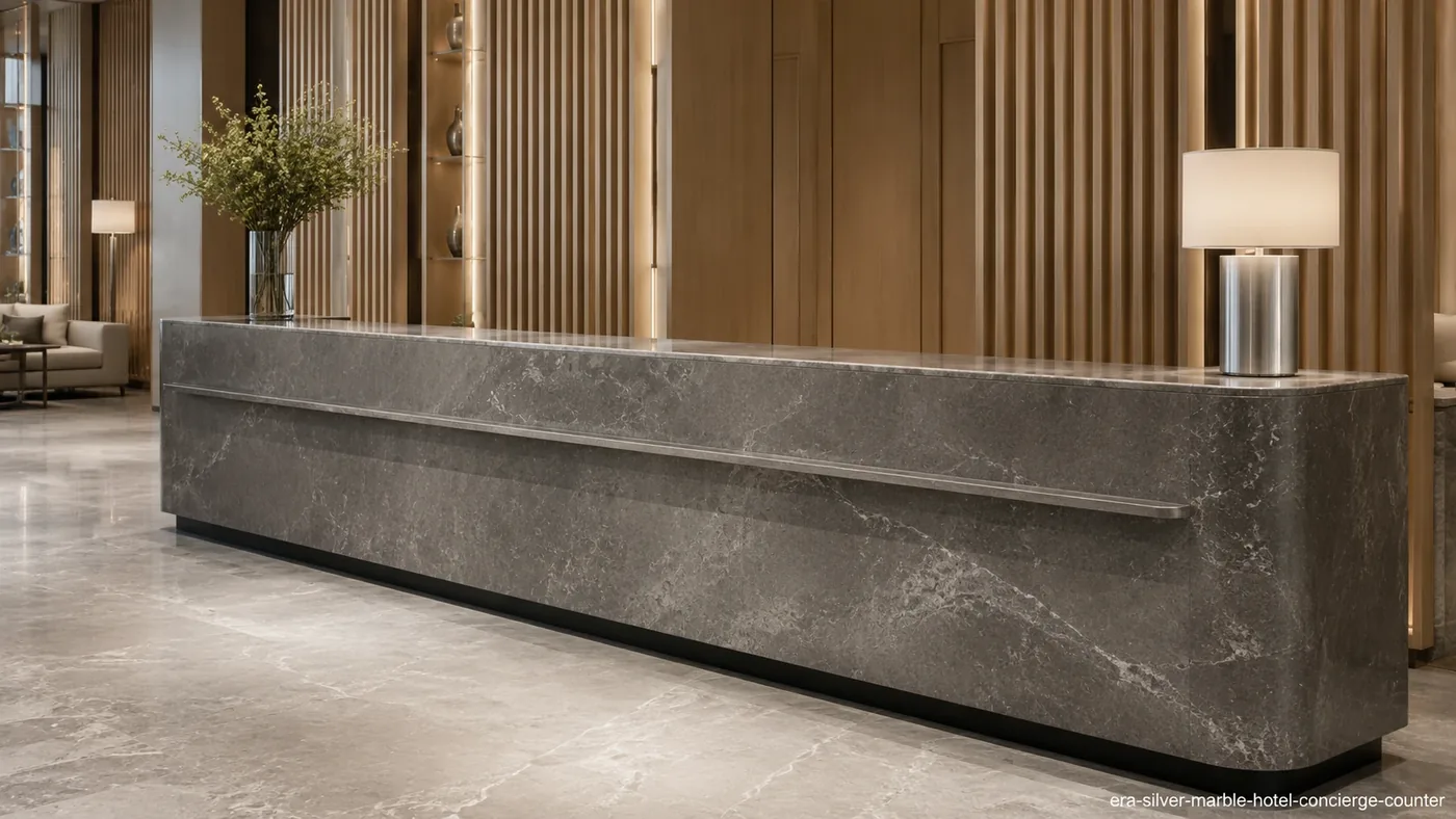 Era Silver Marble hotel concierge counter with a honed graphite-grey fascia and soft pale veining.