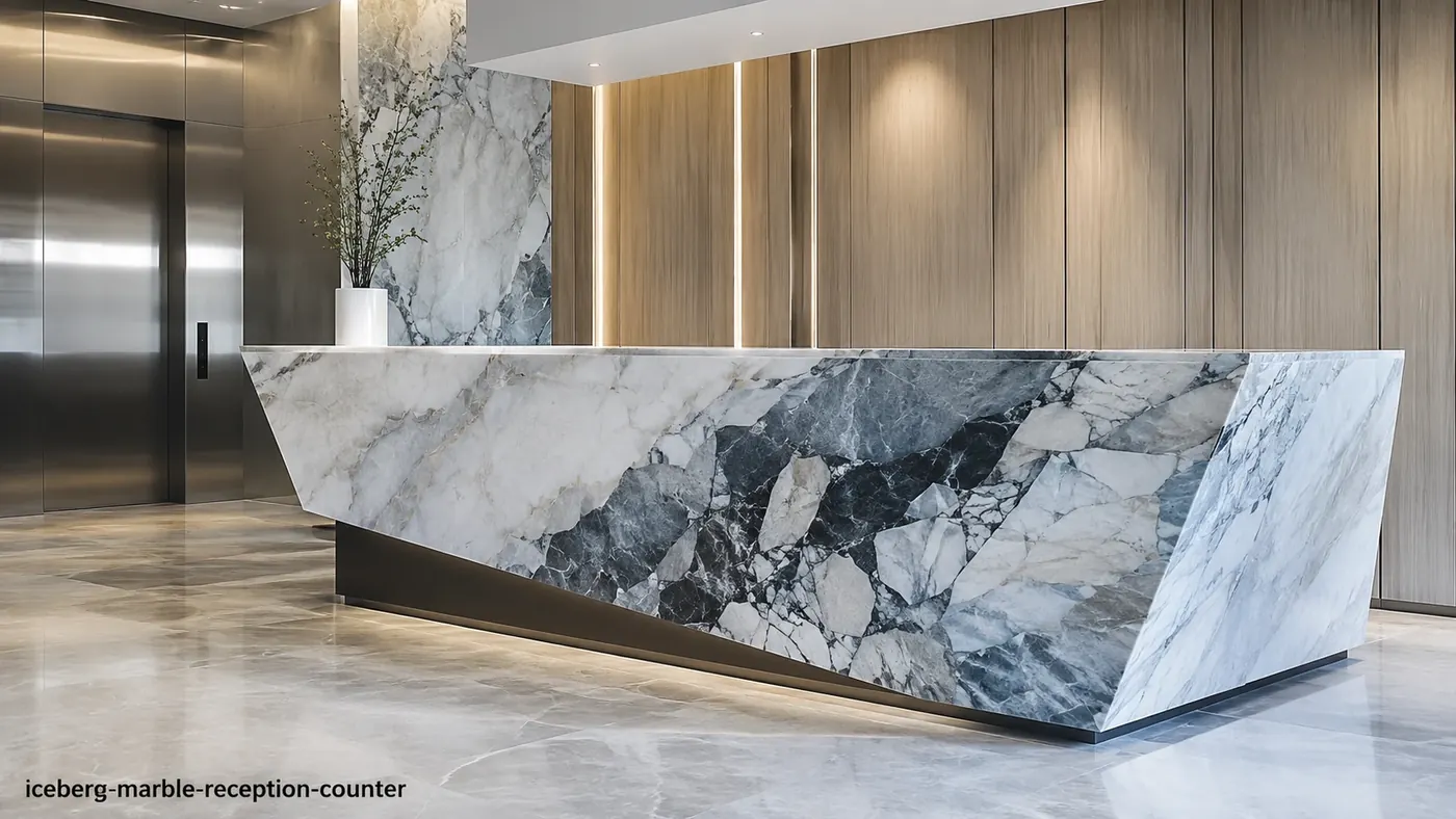 Iceberg Marble reception counter with crystalline white stone, charcoal fractures and icy-blue movement.