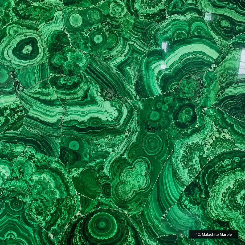 Malachite Marble with banded emerald green stone, concentric rings, flowing stripes and a jewel-like polished stone surface.
