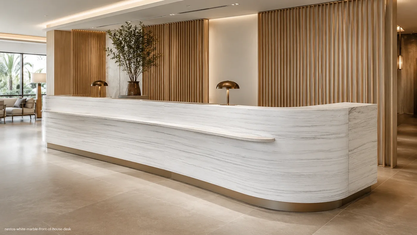 Nestos White Marble front-of-house desk with bright white stone and fine blue-grey and taupe linear veins.