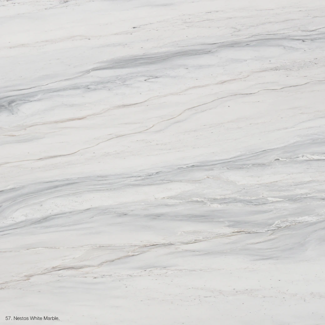 Nestos White Marble with white linear grain stone, pale-grey bands, blue-grey threads and a bright pearlescent stone finish.