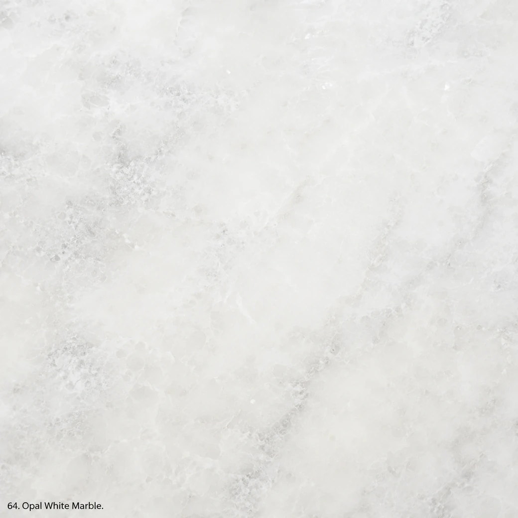 Opal White Marble with translucent white crystalline stone, grey clouds, pearly speckles and a luminous polished finish.