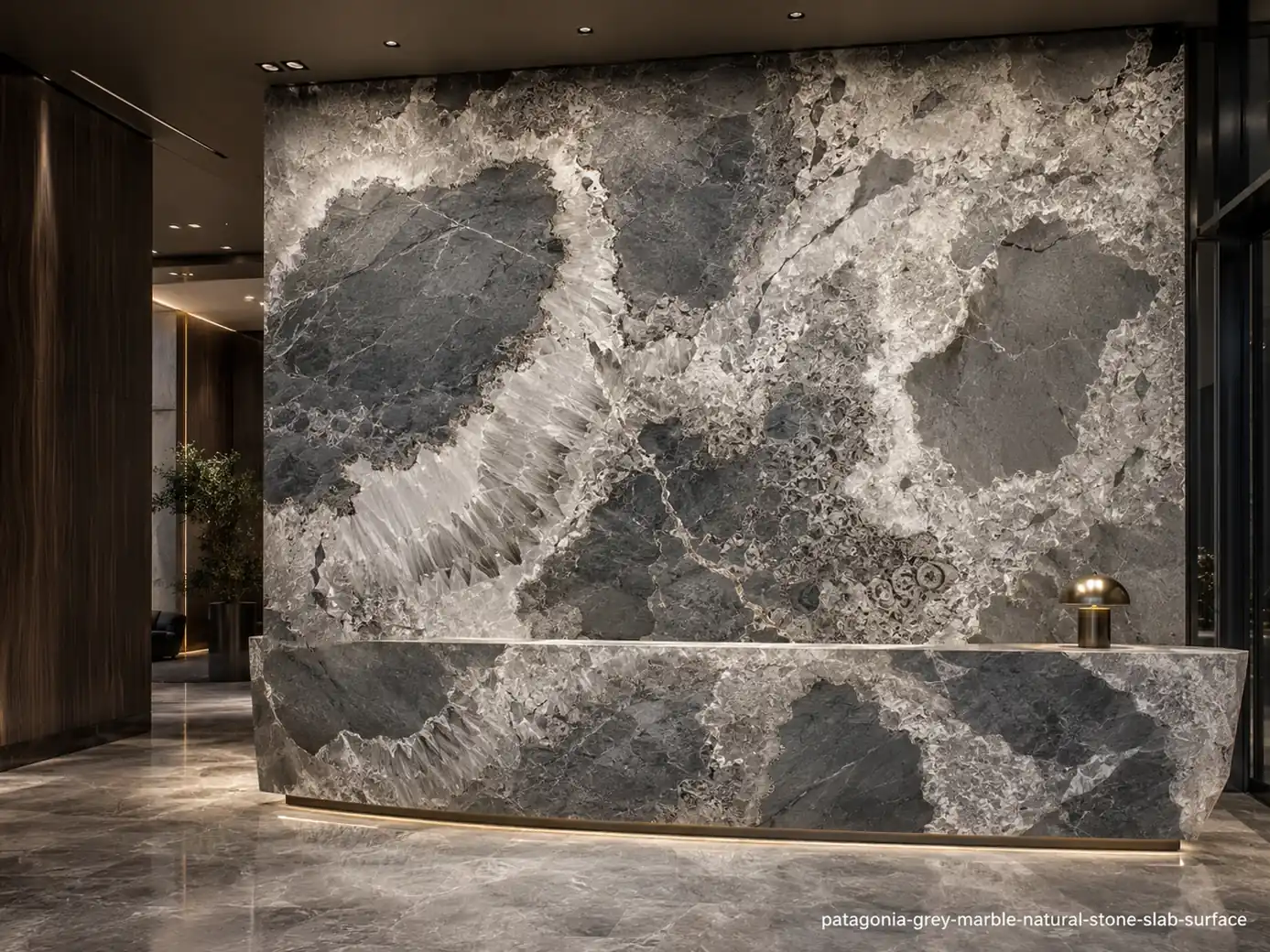 High movement architectural slab on a lobby wall and counter with graphite islands and luminous crystalline white borders.