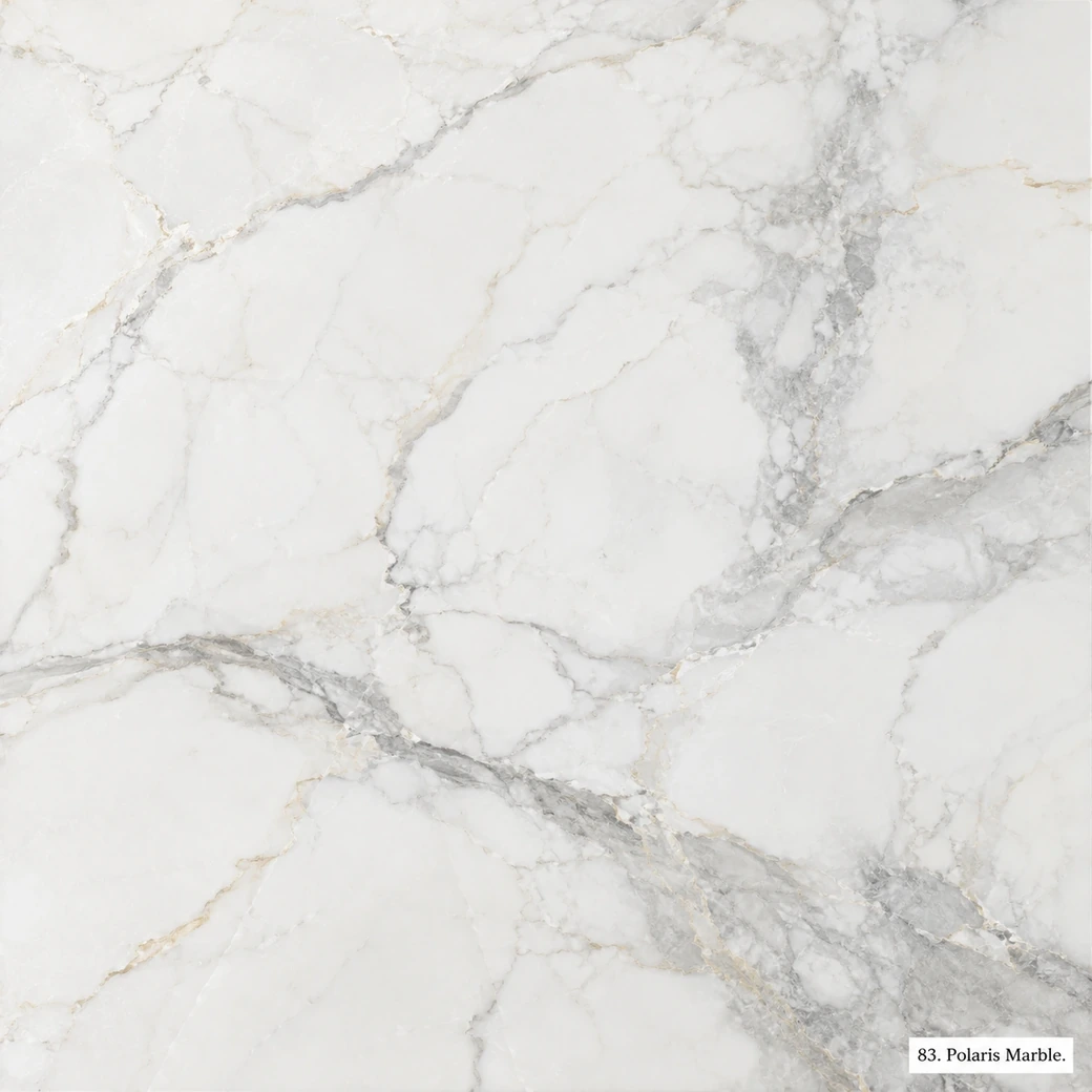 Polaris Marble with bright polar white stone, soft grey veins, pale-gold accents and a clean icy luminous polished finish.