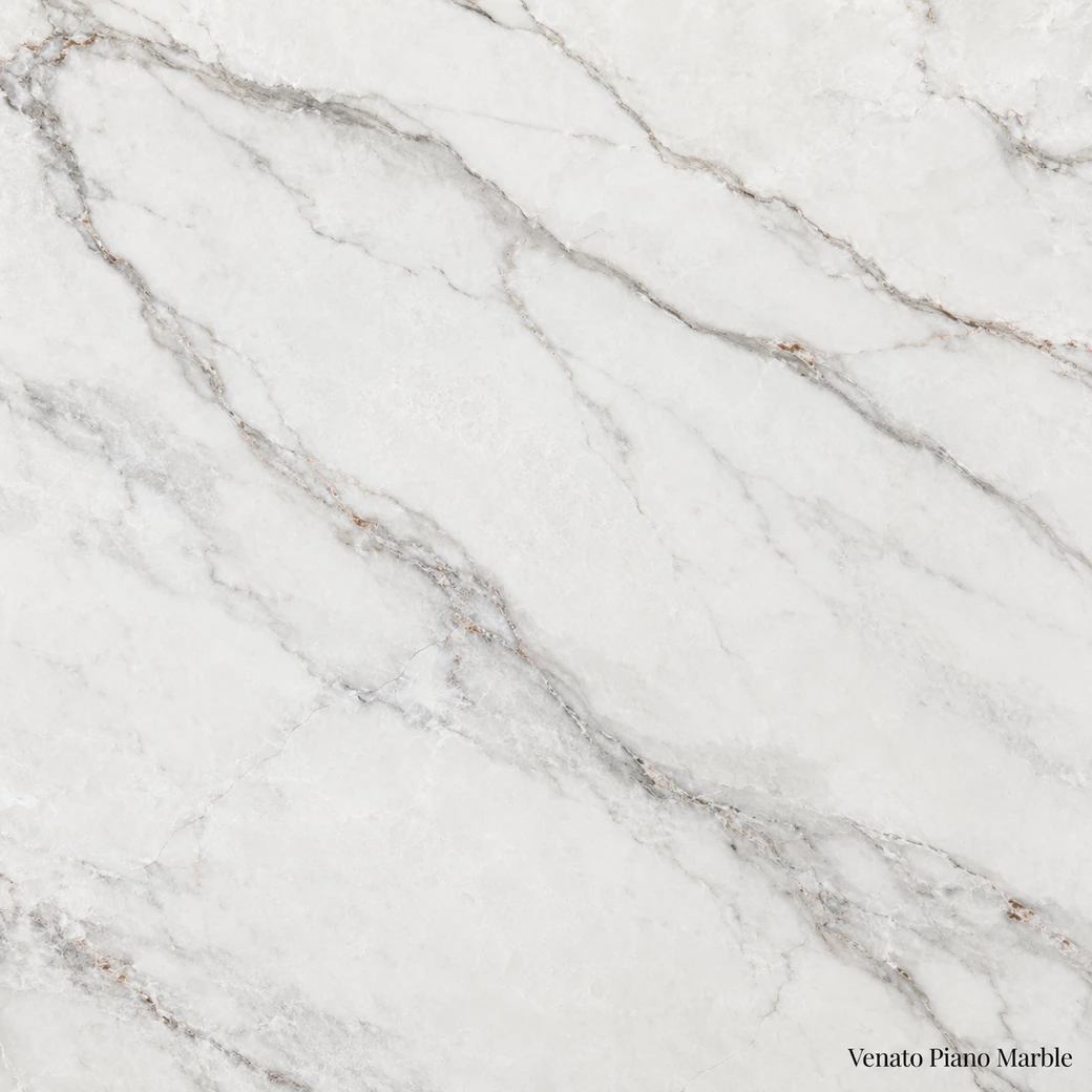 Venato Piano Marble with gently veined white stone, soft grey lines, taupe movement and a bright pearlescent polished finish.