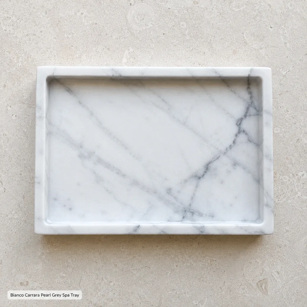 Overhead Bianco Carrara bath tray on limestone with silver-grey veins and silk-honed surface.