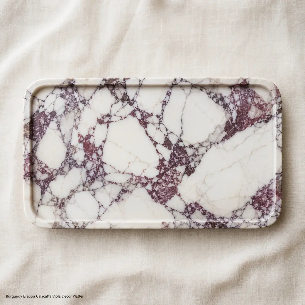 Overhead Calacatta Viola decor tray on pale linen with warm white stone and wine-coloured breccia veins.