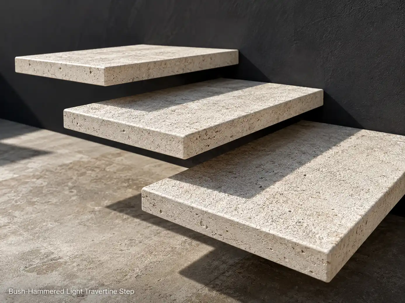 Bush-hammered travertine steps installed as a short floating staircase against a charcoal wall