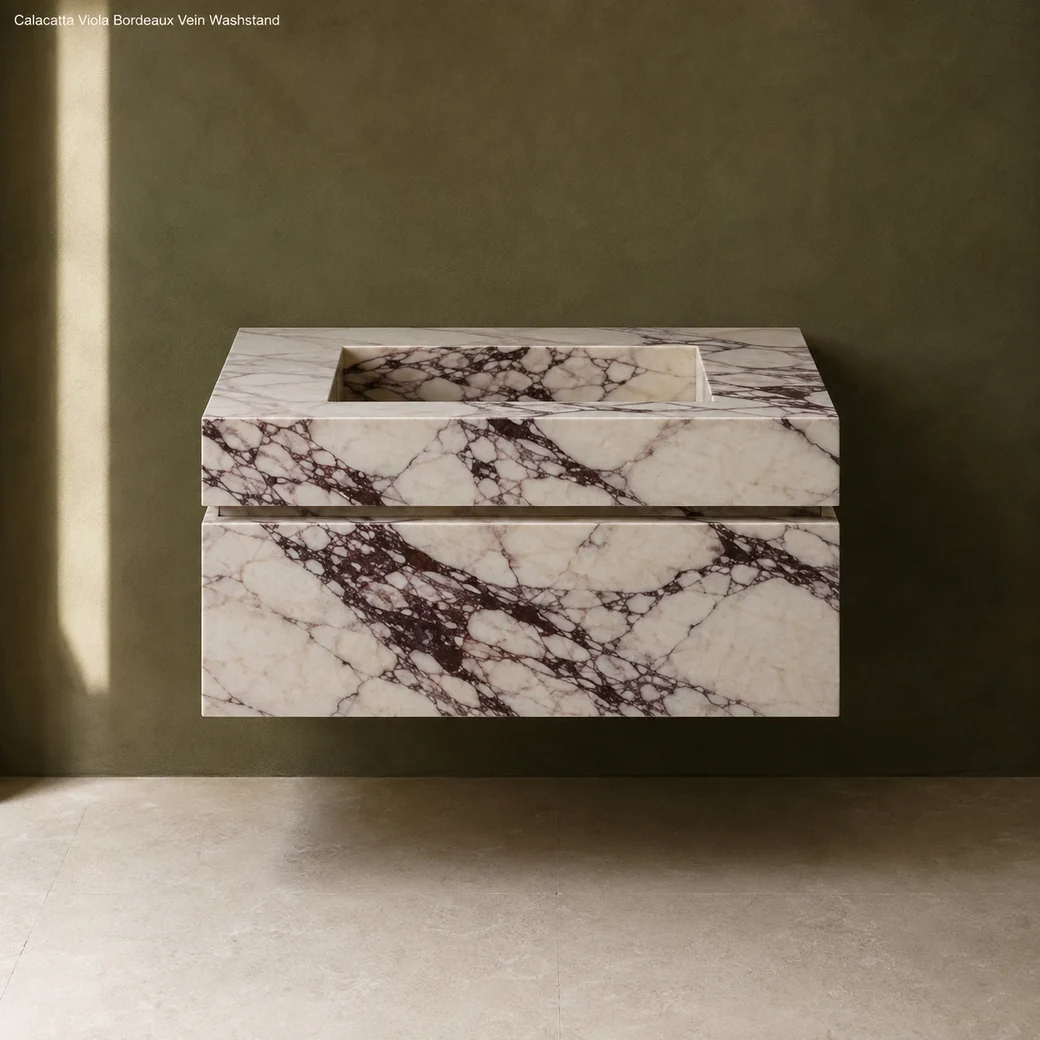 Front-facing Calacatta Viola floating vanity with creamy stone, bold burgundy veins and honed finish