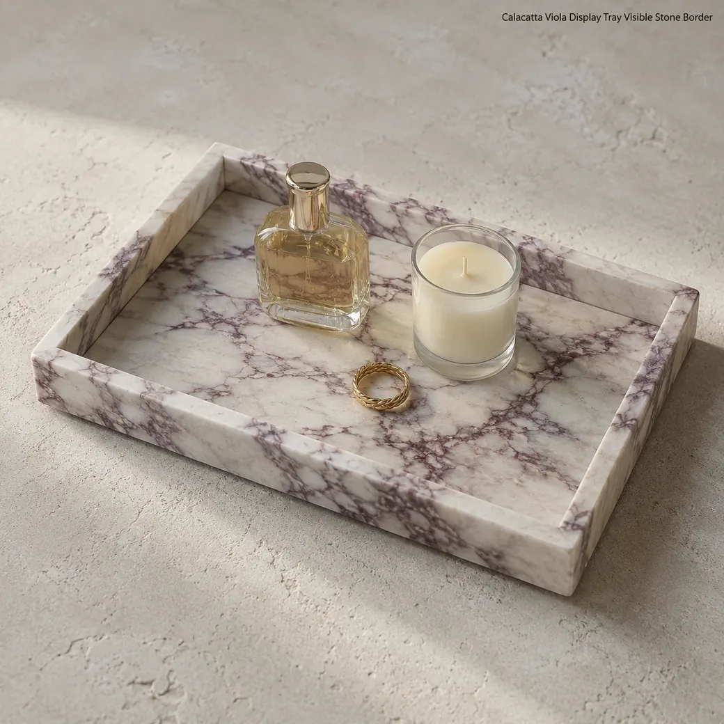 Fine-brushed Calacatta Viola display tray with visible ivory stone border and purple-red veining