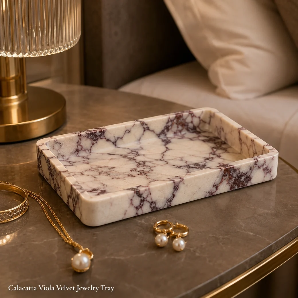 Calacatta Viola jewelry tray in soft cream with burgundy-purple veining and velvet-honed finish.
