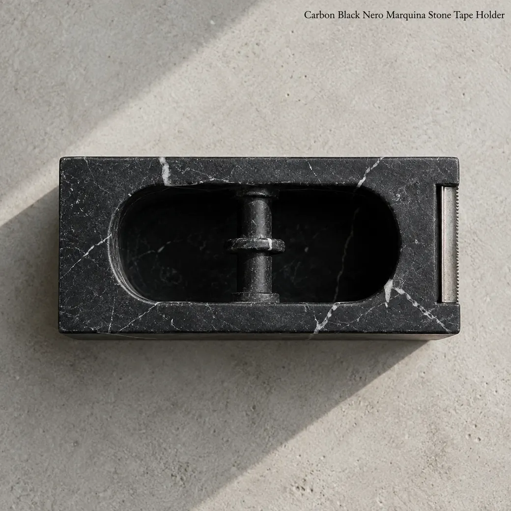 Carbon black Nero Marquina tape holder on pale concrete, overhead view of empty roll recess and white veins