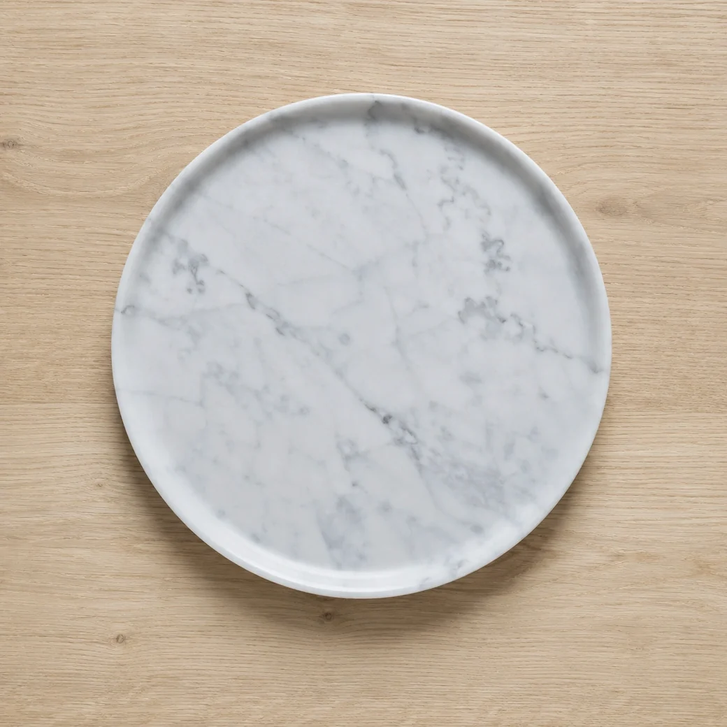 Overhead Carrara White fruit platter on pale oak with fine grey veins and a subtle polished sheen.