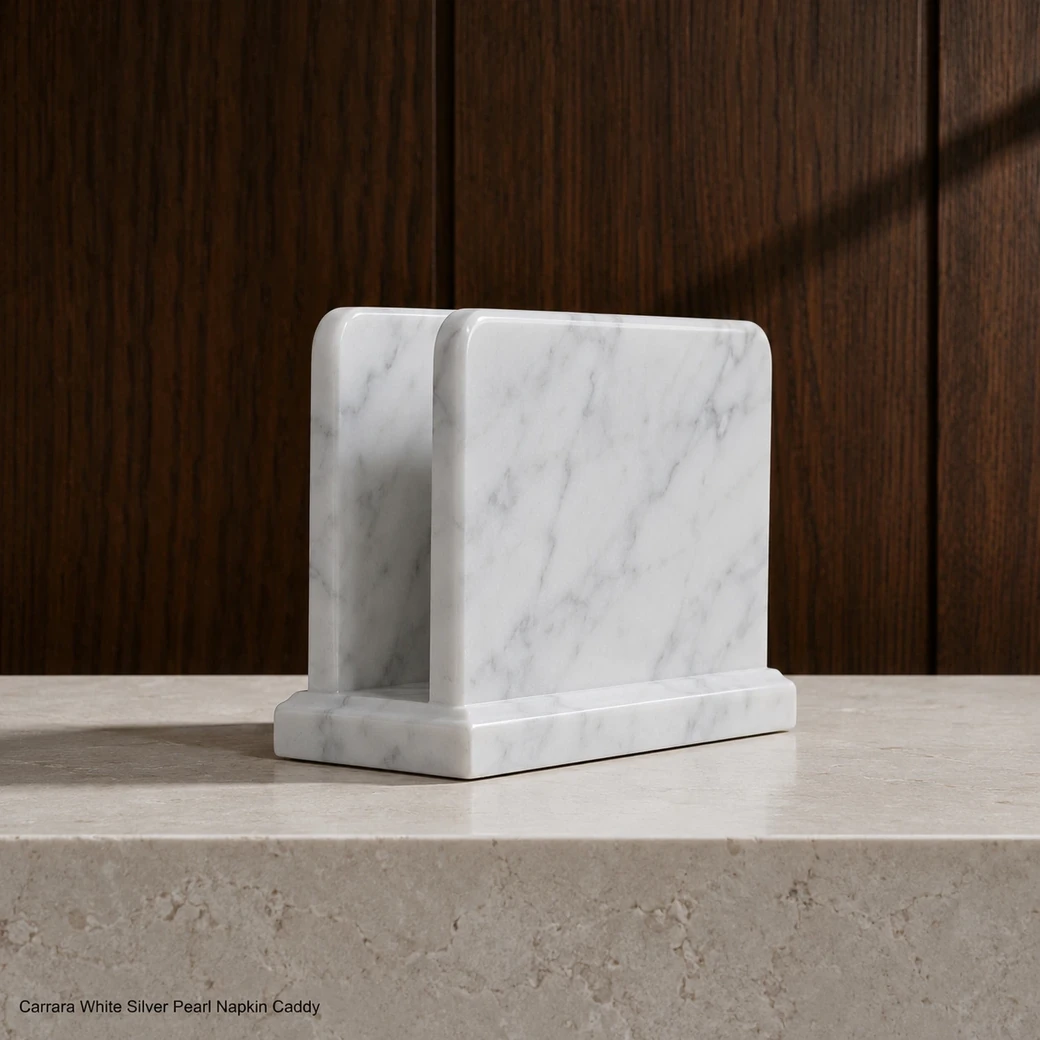 Side-profile pearl white Carrara napkin holder with polished edges and subtle grey veining