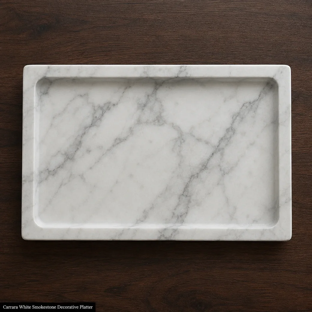 Overhead honed Carrara decorative tray on dark walnut, highlighting smoky grey vein flow and the full recessed interior.