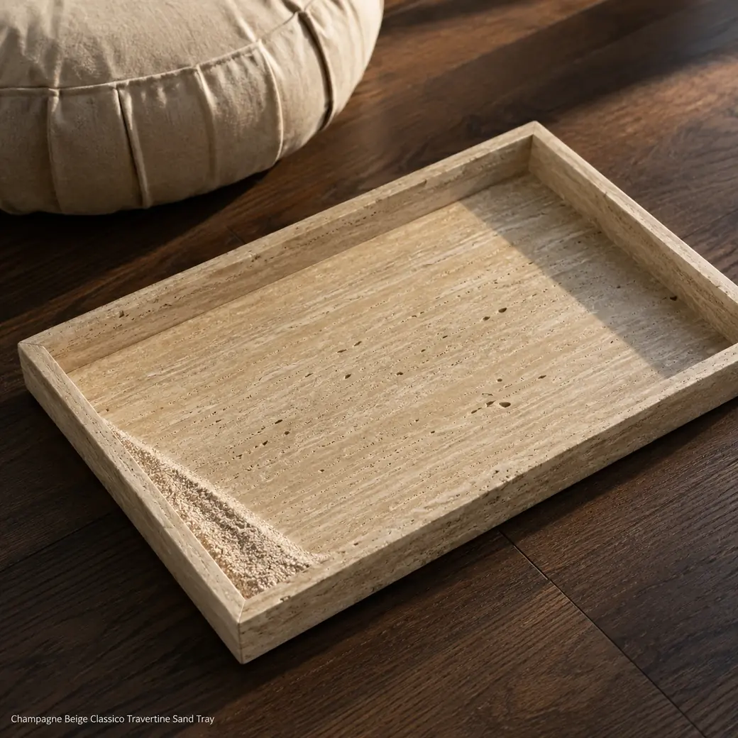 Champagne travertine sand tray on dark walnut floor, overhead angle with pale sand accent and natural brushed pores.