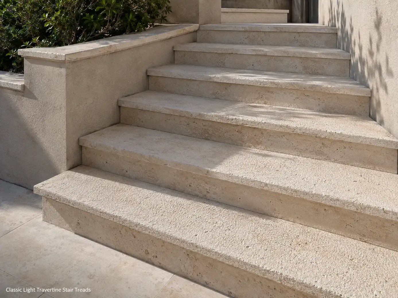 Bush-hammered light travertine stair treads with pale beige texture and professionally finished nosings