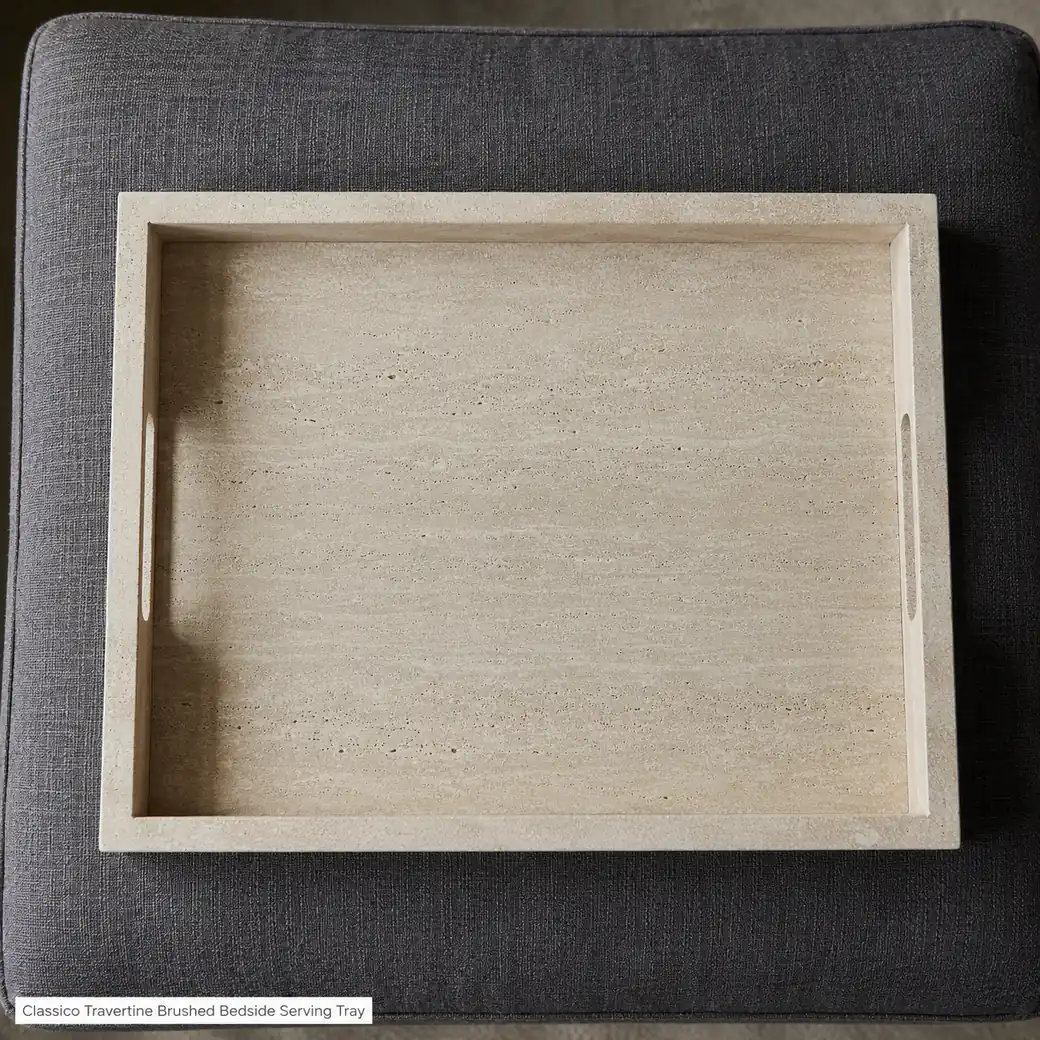 Overhead Classico Travertine bed tray on charcoal linen with grip slots and sand-beige banding.