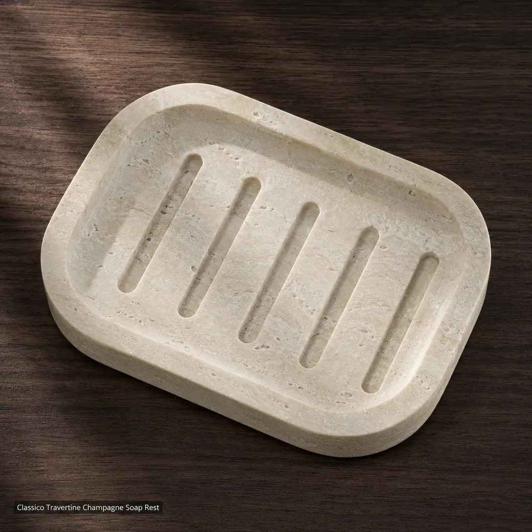 Top-down champagne beige travertine soap dish with carved drainage grooves on dark walnut
