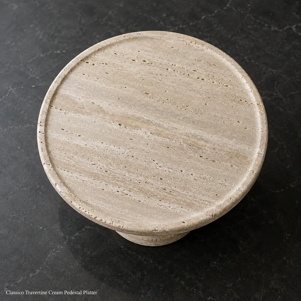 Overhead Classico Travertine pedestal platter on charcoal stone with aged edges and subtle cream banding.