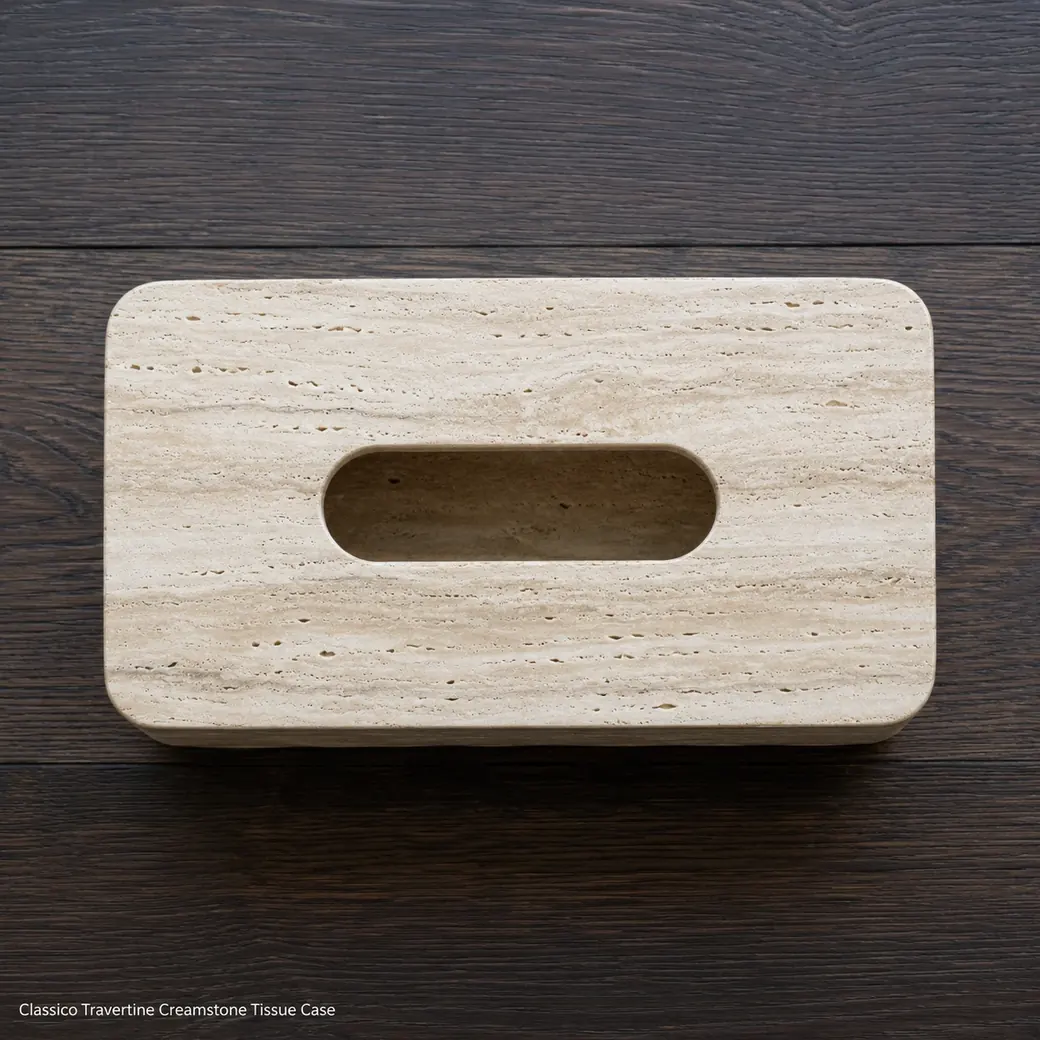 Top-down soft cream Italian travertine tissue box on smoked oak with visible oval opening