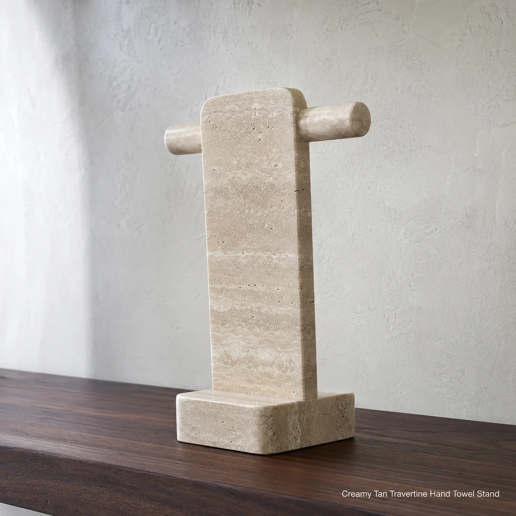 Creamy tan travertine towel stand on dark walnut shelf, rear-side view emphasizing stone profile and sanded texture.
