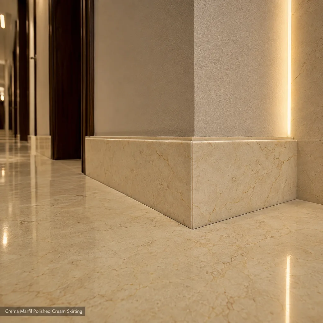 Crema Marfil skirting meeting at a polished mitred hallway corner under warm grazing architectural light.