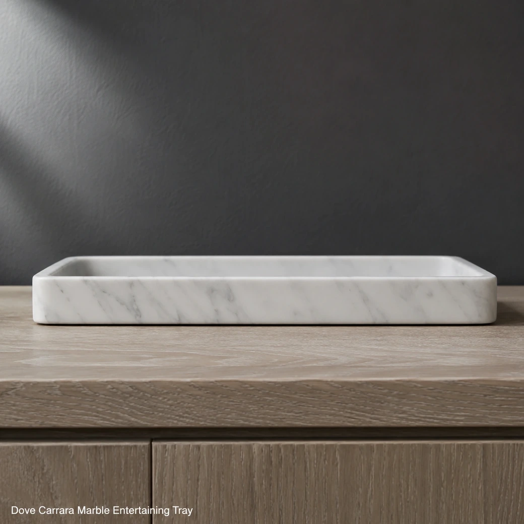 End-on Carrara serving tray on pale oak with dove-white honed stone and soft grey movement.