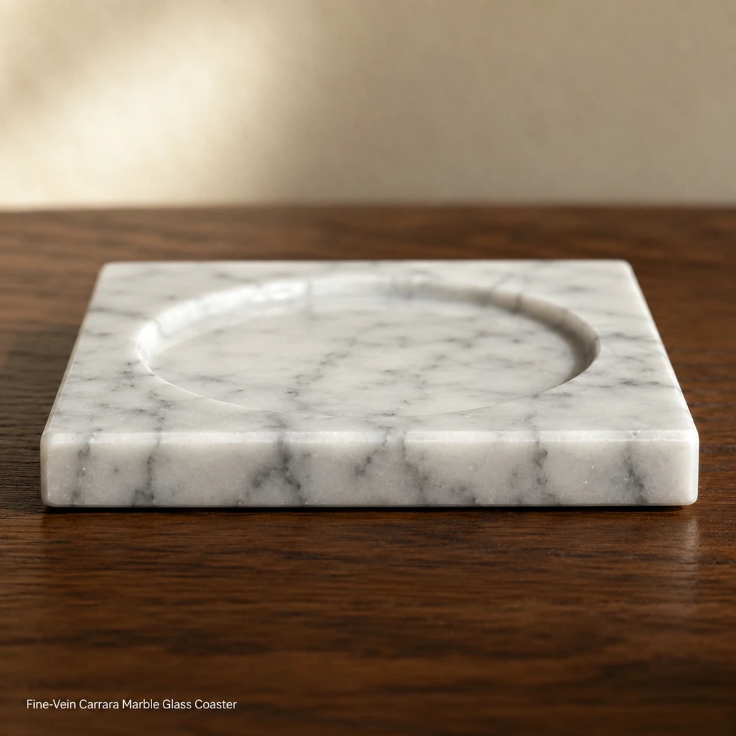 Fine-vein Carrara glass coaster on walnut surface, edge-level macro showing polished recess and 1 cm stone thickness.