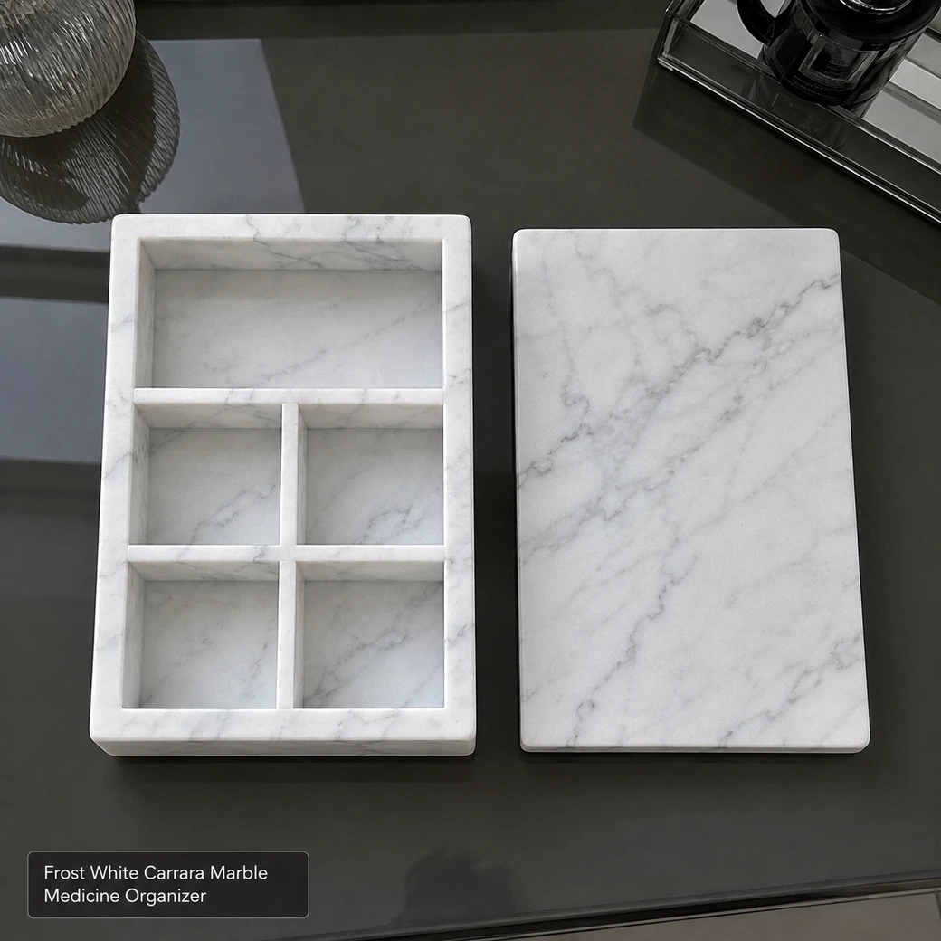 Frost white Carrara medicine organizer on smoked glass, overhead view with lid removed and empty compartments