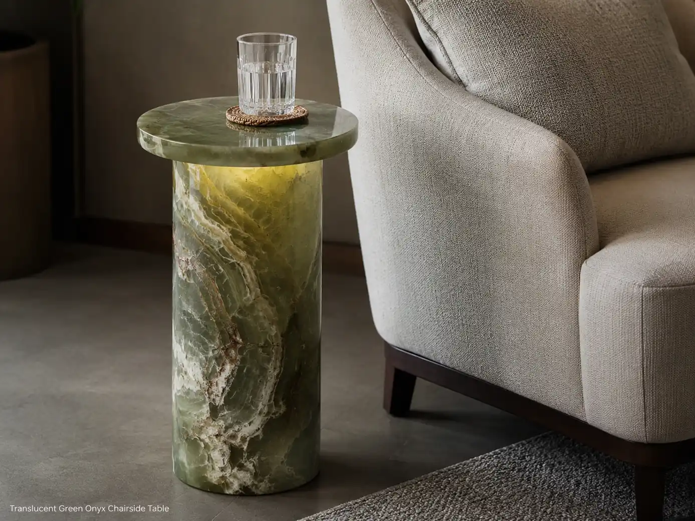 Polished green onyx drink table beside lounge seating with translucent bands and subtle concealed lighting