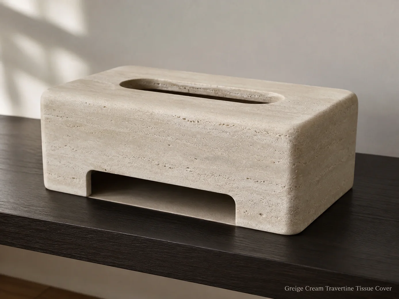 Empty greige travertine tissue cover viewed from the rear on a dark espresso wood shelf