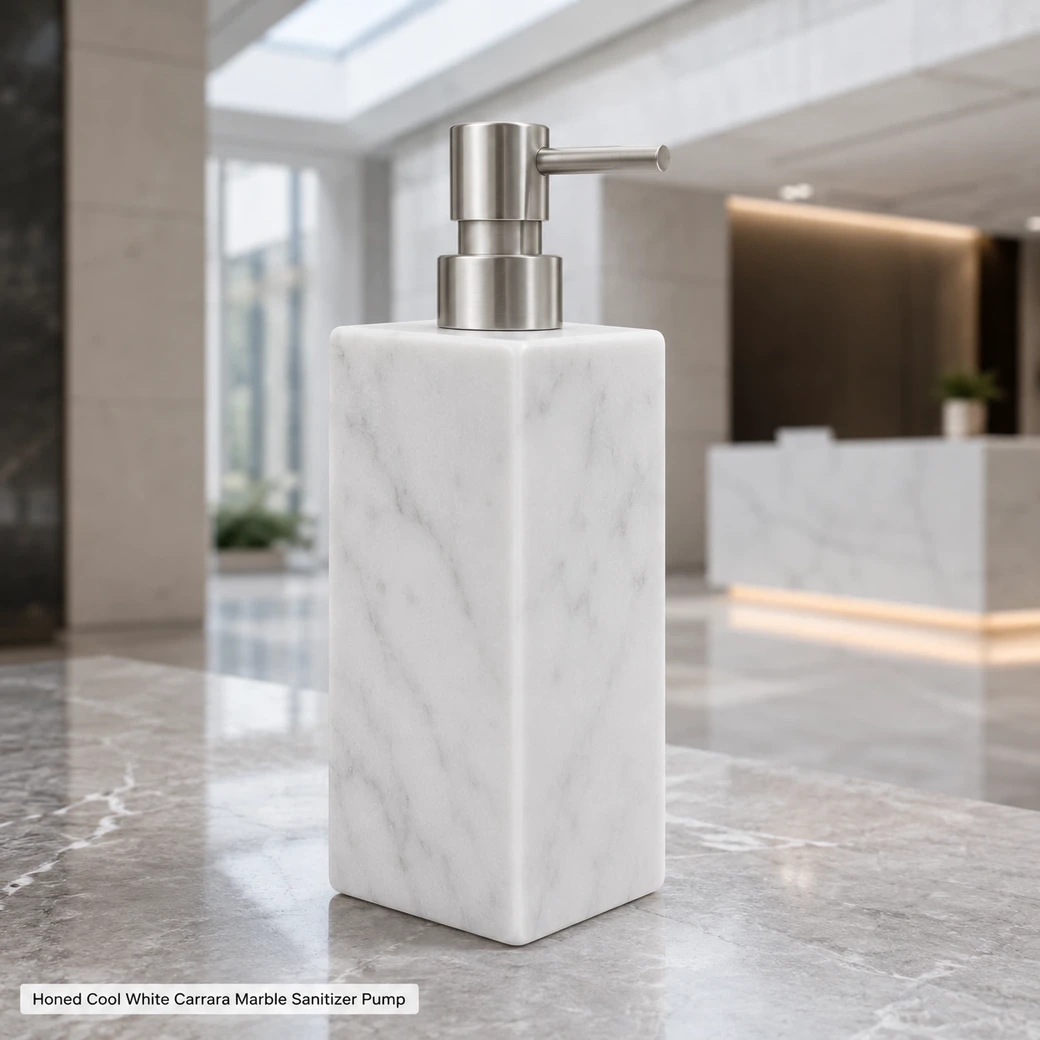 Cool white Carrara sanitizer pump on reception desk, rear-side view showing honed veins and minimalist metal pump.