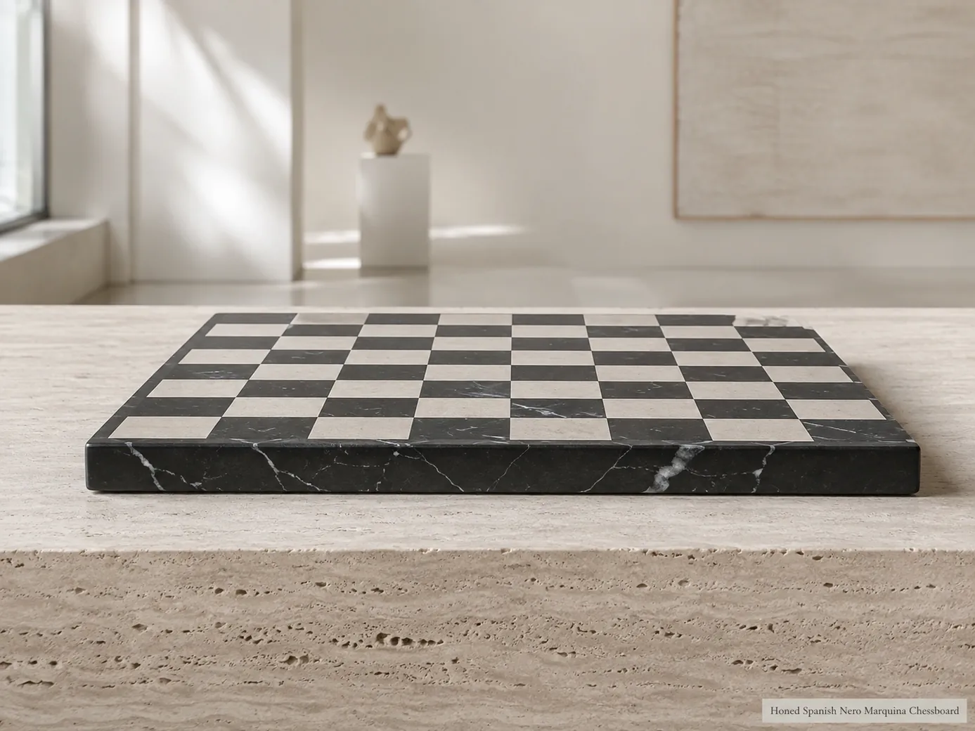 Empty Nero Marquina chessboard shown from low tabletop height on a pale travertine console