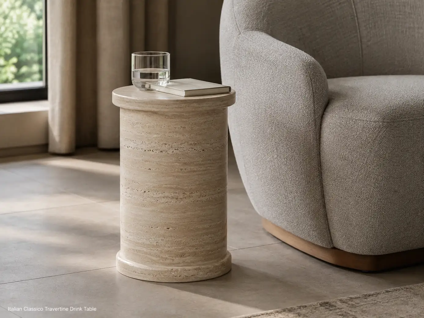 Honed Italian Classico travertine drink table beside a lounge chair with warm beige stone and natural pores
