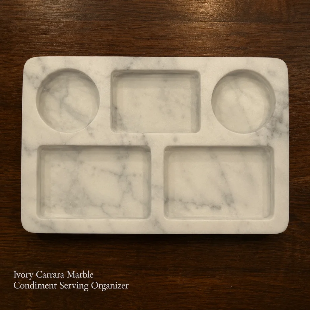 Ivory Carrara condiment organizer on dark walnut, overhead view showing the empty carved wells and honed surface