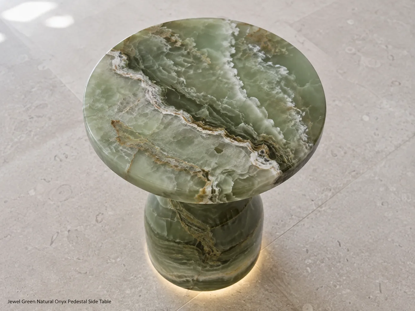 Jewel green onyx side table viewed from above on pale limestone with subtle base illumination